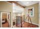 Bright upper landing with telescope, chandelier, and views to the lower level at 1 Gooseberry Ln, Cherry Hills Village, CO 80113