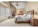 Cozy main bedroom featuring a stone fireplace, carpet, and wooden accents at 1 Gooseberry Ln, Cherry Hills Village, CO 80113