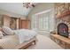 Inviting main bedroom with a stone fireplace, window seat, and ample natural light at 1 Gooseberry Ln, Cherry Hills Village, CO 80113