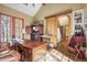 Cozy home office with hardwood floors, exposed beam ceiling, and stylish barn door at 1 Gooseberry Ln, Cherry Hills Village, CO 80113