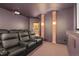 Home theater with tiered seating, projector, and sconce lighting on decorative columns at 1 Gooseberry Ln, Cherry Hills Village, CO 80113