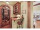 Elegant wine room featuring an iron gate, custom cabinetry, and a built-in bar area at 1 Gooseberry Ln, Cherry Hills Village, CO 80113