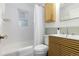 Clean bathroom with a modern vanity, bathtub, and shower at 5115 Bryant St, Denver, CO 80221