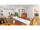 Warm dining room with wooden table and view into living room and kitchen at 5115 Bryant St, Denver, CO 80221