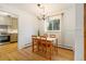 Bright dining room with hardwood floors, natural light and view to kitchen at 5115 Bryant St, Denver, CO 80221