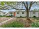 Charming single-story home with a well-maintained front yard and vibrant orange front door at 5115 Bryant St, Denver, CO 80221
