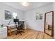 Bright home office space with natural light, modern desk, and hardwood floors at 5115 Bryant St, Denver, CO 80221