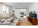 Living room showcasing sliding door leading to a bedroom with a brick fireplace and a TV set at 5115 Bryant St, Denver, CO 80221