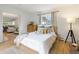 Comfortable main bedroom with a window, a dresser, and a view into the living room at 5115 Bryant St, Denver, CO 80221