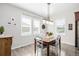 Bright dining room with wooden table, chairs, and large windows at 10761 N Montane Dr, Broomfield, CO 80021