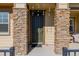 Dark green front door with stone accents at 10761 N Montane Dr, Broomfield, CO 80021