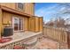 Fenced backyard with a small patio and mature trees at 11901 E Kepner Dr, Aurora, CO 80012