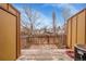 Fenced backyard with a small patio and mature trees at 11901 E Kepner Dr, Aurora, CO 80012