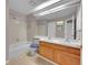 Bathroom with double sinks, and a mirror above a wood vanity at 11901 E Kepner Dr, Aurora, CO 80012