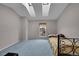 Bedroom featuring a single bed, skylights, and a view through the window at 11901 E Kepner Dr, Aurora, CO 80012