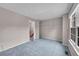 Bedroom featuring neutral walls, soft carpet, window and closet at 11901 E Kepner Dr, Aurora, CO 80012