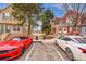 Street view of townhouses with front yard and a parking lot with 2 cars at 11901 E Kepner Dr, Aurora, CO 80012