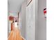 Hallway view featuring hardwood floors, neutral paint, closet, and a glimpse of a living room at 11901 E Kepner Dr, Aurora, CO 80012