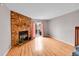 Spacious living room showcasing hardwood floors, brick fireplace, and sliding glass doors at 11901 E Kepner Dr, Aurora, CO 80012