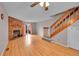 Inviting living room with wood floors, brick fireplace, and staircase at 11901 E Kepner Dr, Aurora, CO 80012