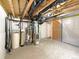 Unfinished basement with exposed beams, mechanicals and door at 9486 E 107Th Ave, Commerce City, CO 80640