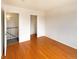 Bedroom featuring hardwood floors, closet, and stairs at 9486 E 107Th Ave, Commerce City, CO 80640