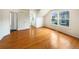 Bedroom featuring hardwood floors, natural light, and an ensuite bathroom at 9486 E 107Th Ave, Commerce City, CO 80640