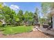Expansive backyard featuring lush greenery, mature trees, and a patio perfect for outdoor entertaining at 1441 Cherry Pl, Erie, CO 80516