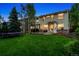 Expansive backyard with lush green lawn, patio area, and mature trees, perfect for outdoor living at 1441 Cherry Pl, Erie, CO 80516