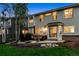 Evening view of the backyard patio with outdoor seating, grill, and well-lit exterior of the home at 1441 Cherry Pl, Erie, CO 80516