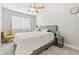 Cozy bedroom with plush carpet, natural light, and a comfortable bed with decorative pillows and side tables at 1441 Cherry Pl, Erie, CO 80516