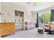 Neutral Bedroom features a crib, glider and a view of the backyard trees at 1441 Cherry Pl, Erie, CO 80516