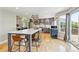 Modern kitchen features an island with seating, stainless steel appliances, and hardwood floors at 1441 Cherry Pl, Erie, CO 80516
