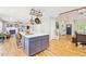 Stylish kitchen with a central island, hardwood floors, and an open layout connecting to the living room at 1441 Cherry Pl, Erie, CO 80516