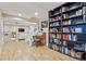 Cozy living room with desk, large bookcase, staircase and lower-level access create inviting and functional space at 1441 Cherry Pl, Erie, CO 80516