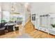 Bright living room featuring hardwood floors, a modern staircase, and a view of the adjacent kitchen at 1441 Cherry Pl, Erie, CO 80516