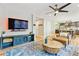 Open-concept living space featuring hardwood floors, modern ceiling fan, and view to the kitchen at 1441 Cherry Pl, Erie, CO 80516