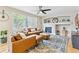 Inviting living room with a ceiling fan, a tiled fireplace, and stylish decor at 1441 Cherry Pl, Erie, CO 80516