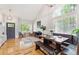 Sunlit living room and dining area, with hardwood floors and modern furnishings at 1441 Cherry Pl, Erie, CO 80516