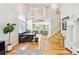 Bright, open-concept living room with dining area, beautiful staircase, and hardwood floors at 1441 Cherry Pl, Erie, CO 80516