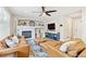 Cozy living room with modern ceiling fan, white brick fireplace, and comfortable leather seating at 1441 Cherry Pl, Erie, CO 80516