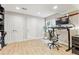 Home office with wood floors, natural light, sleek desk, and black mesh ergonomic chair, providing a modern work space at 1441 Cherry Pl, Erie, CO 80516