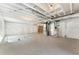 Unfinished basement with exposed ceiling, concrete floor, and white plastic vapor barrier on walls at 18800 E 55Th Ave, Denver, CO 80249