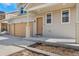 Home with a two-car garage and inviting porch creates a warm and welcoming entrance for guests and residents at 18800 E 55Th Ave, Denver, CO 80249
