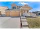 Beautiful home features a welcoming facade, two-car garage, and well-maintained landscaping in a desirable neighborhood at 18800 E 55Th Ave, Denver, CO 80249