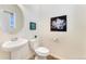 Half bathroom with a pedestal sink, modern fixtures, and decorative wall art offers convenience for guests at 18800 E 55Th Ave, Denver, CO 80249