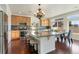 Spacious kitchen with a large island, stainless steel appliances, and hardwood floors at 18800 E 55Th Ave, Denver, CO 80249
