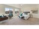 Sun-filled main bedroom with sitting area, carpet and neutral decor at 18800 E 55Th Ave, Denver, CO 80249
