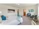 Spacious main bedroom featuring neutral tones, carpeting, and comfortable sitting area at 18800 E 55Th Ave, Denver, CO 80249