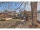 A backyard with raised garden beds, trees, and gravel at 339 Delaware St, Denver, CO 80223